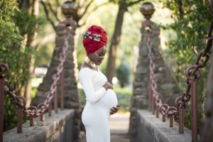 African pregnant woman wearing white maternity dress